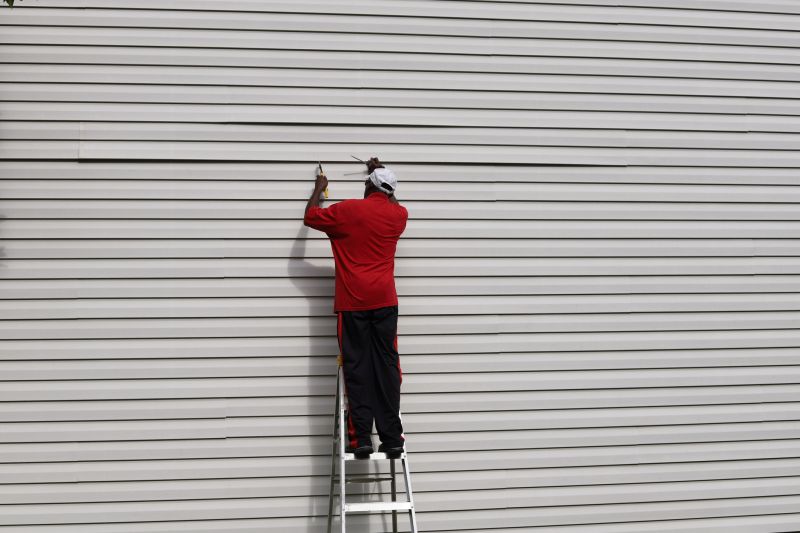 Professional preparing siding materials